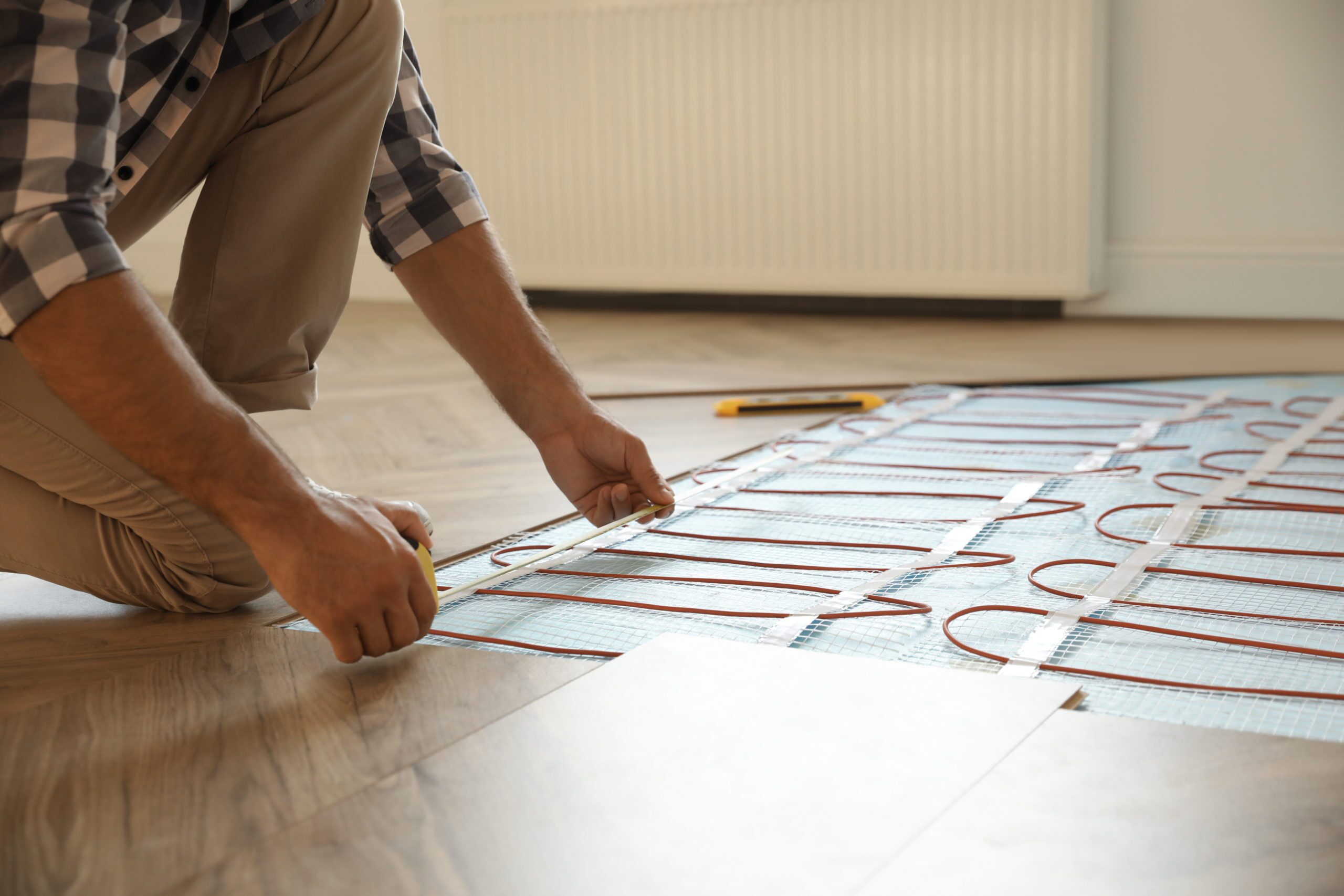 man installing radiant flooring