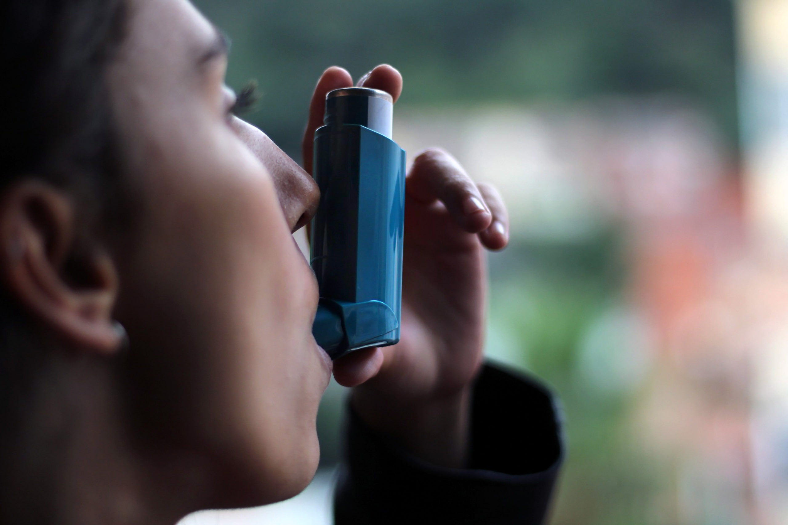 man using an inhaler