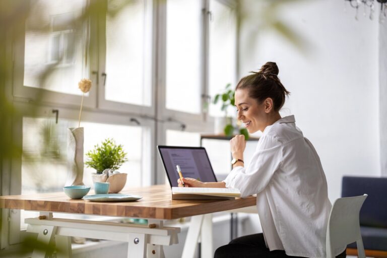woman working from a table at her office