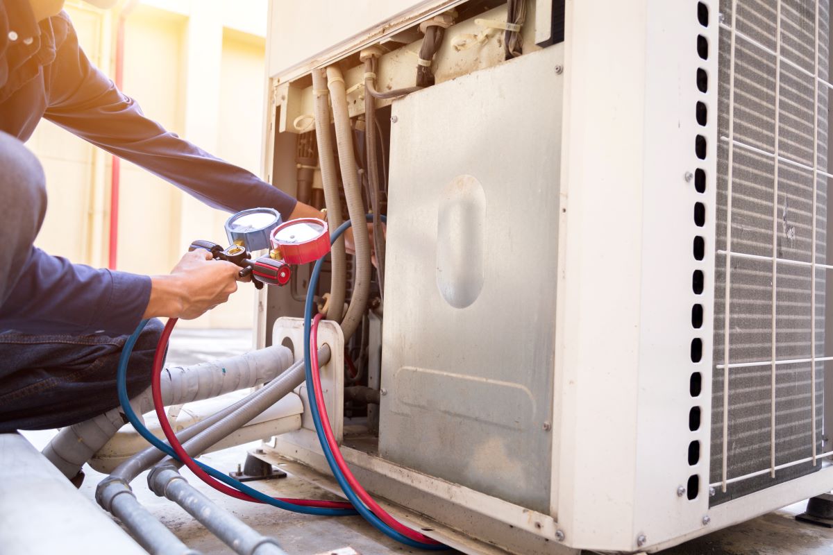 tech repairing hvac unit