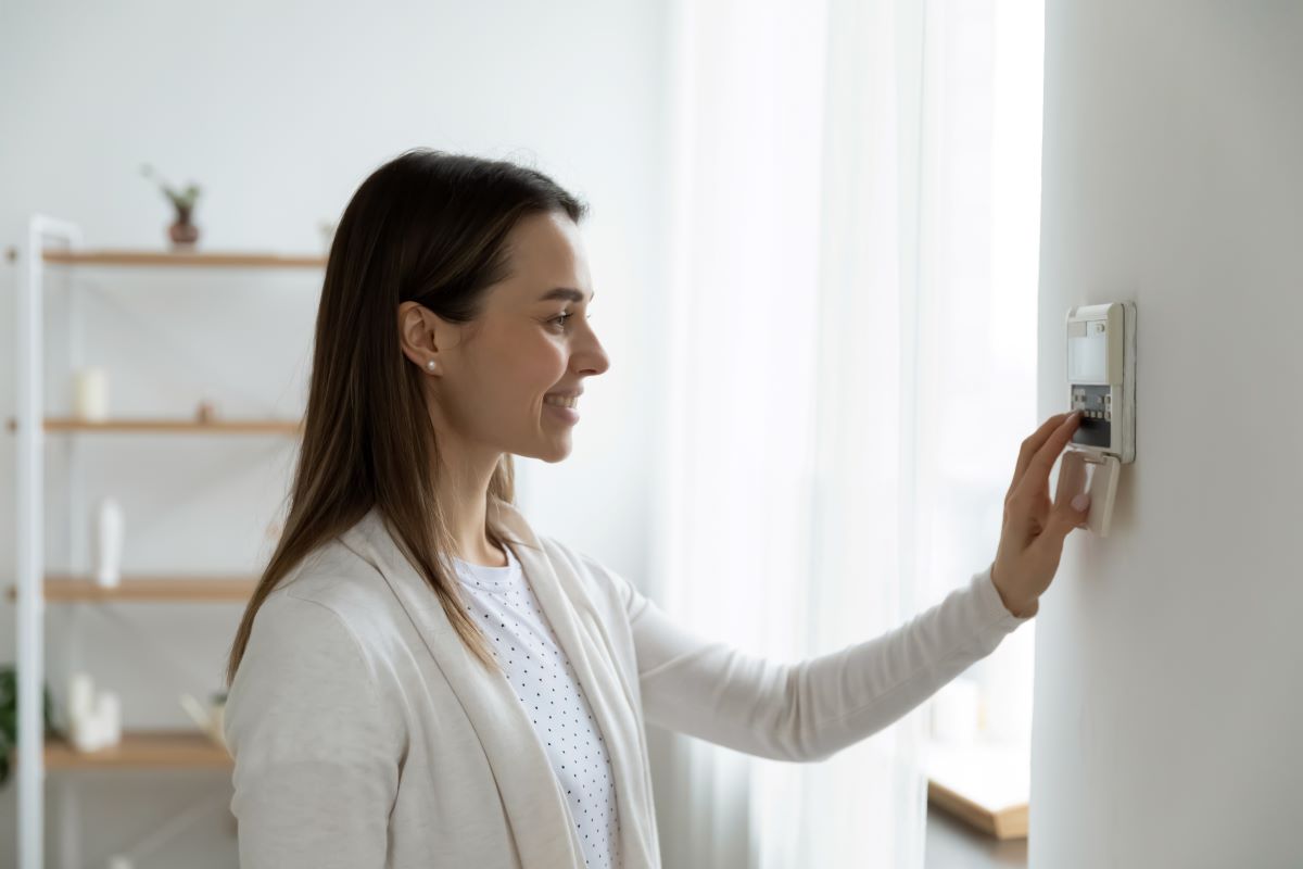 lady changing the temperature in house